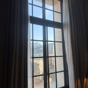 Made-to-measure aluminium secondary glazing fitted to a tall period window