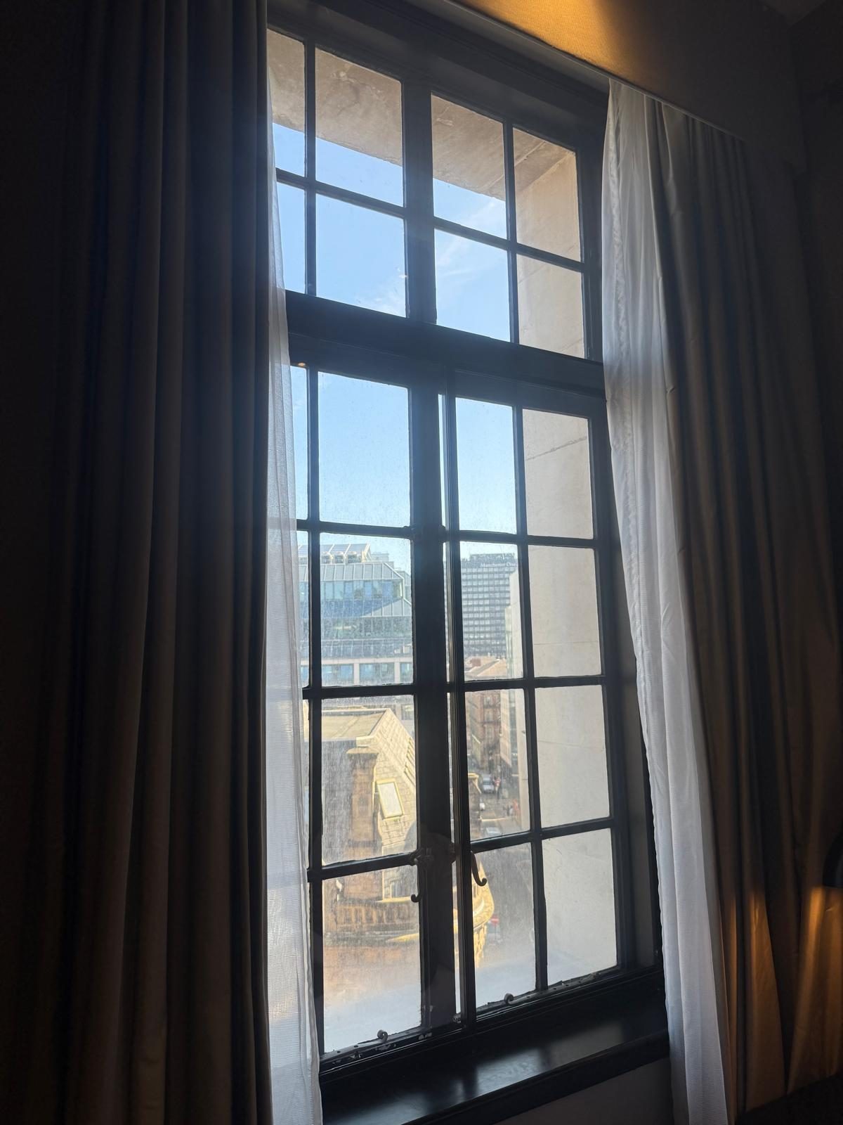 Made-to-measure aluminium secondary glazing fitted to a tall period window