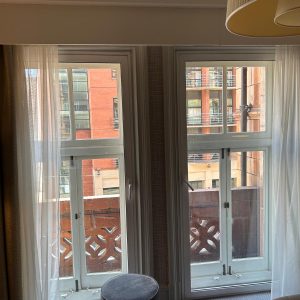 White hinged secondary glazing fitted to a pair of tall period windows