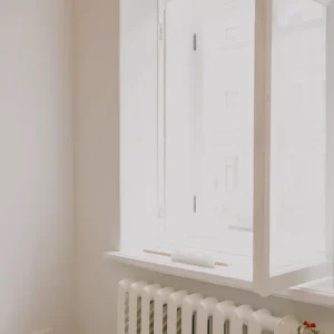 Simple bright room with a white-framed window above a radiator
