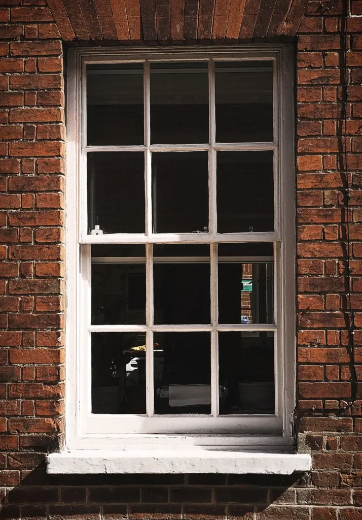 White sash window with Georgian-style glazing bars, suitable for secondary glazing